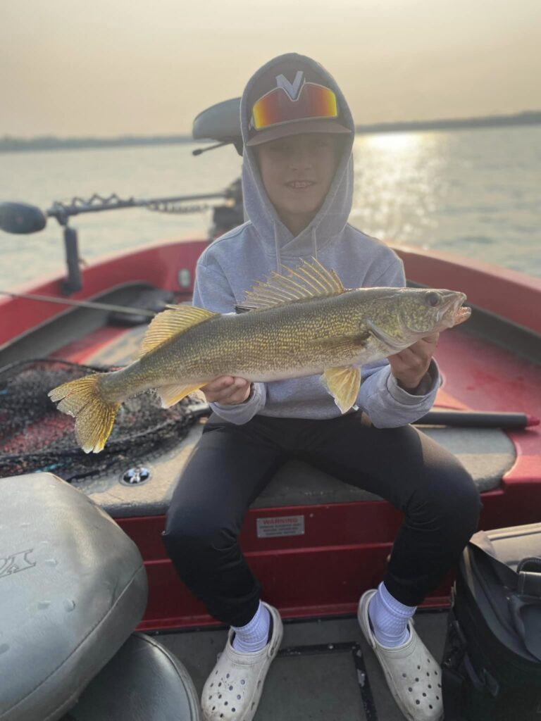 Young stud with a new personal best walleye while fishing Cass Lake with Cass Lake Area Guide Service guide Corbin Hime.